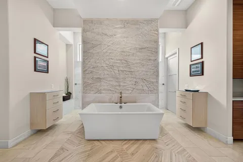 a white tub sitting next to a white sink
