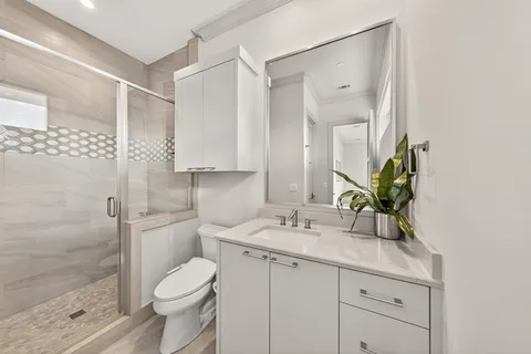 a bathroom with a sink toilet and shower