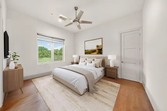 a bedroom with a large bed and a window