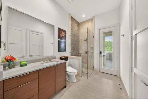 a bathroom with a double vanity sink mirror and toilet