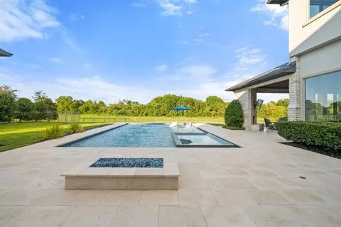 a view of a house with swimming pool and a yard