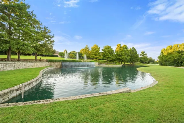 a view of a house with swimming pool and chairs