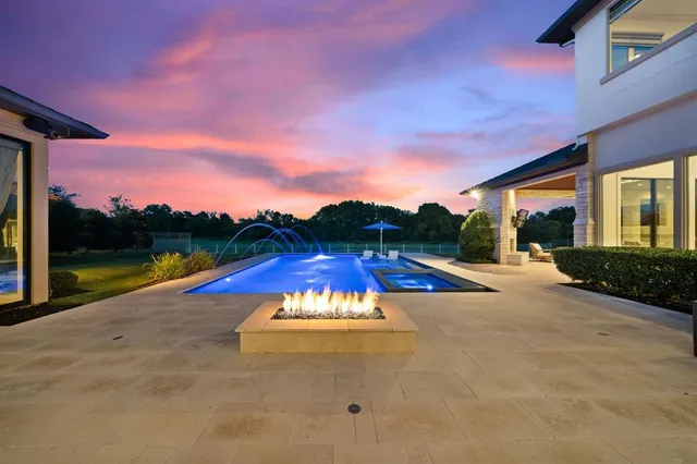 an aerial view of a house with a garden and lake view