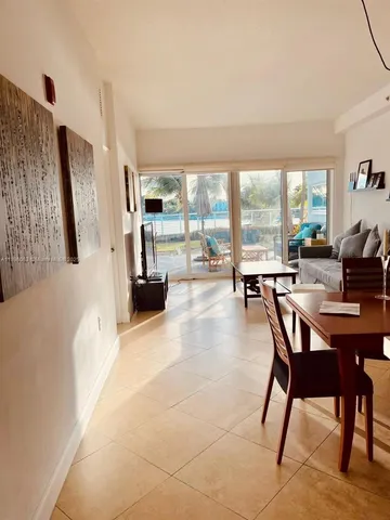 a living room with furniture and large windows