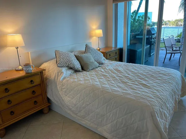 a bedroom with a bed and a night stand