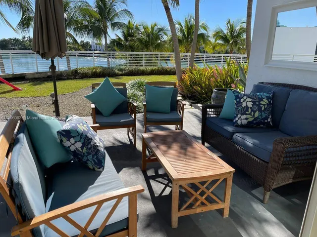 a view of a backyard with furniture and a patio