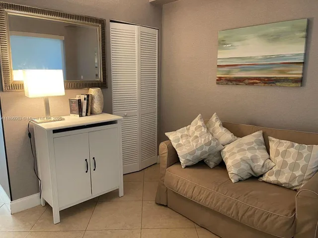 a living room with a couch and a dresser