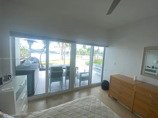 a spacious bedroom with a balcony a bed and a couch