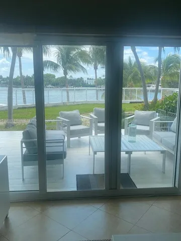 a view of a living room and floor to ceiling window or lake