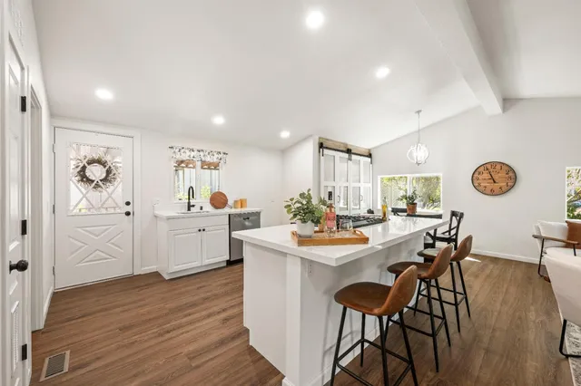 a view of a dining room with furniture and wooden floor