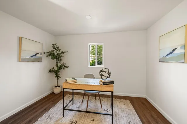 a workspace room with furniture and wooden floor