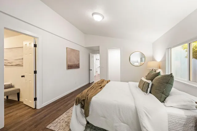 a bedroom with a bed and a window