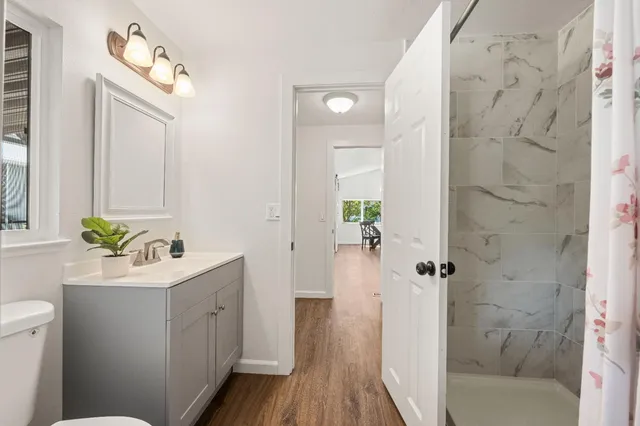 a bathroom with a sink a mirror and a shower