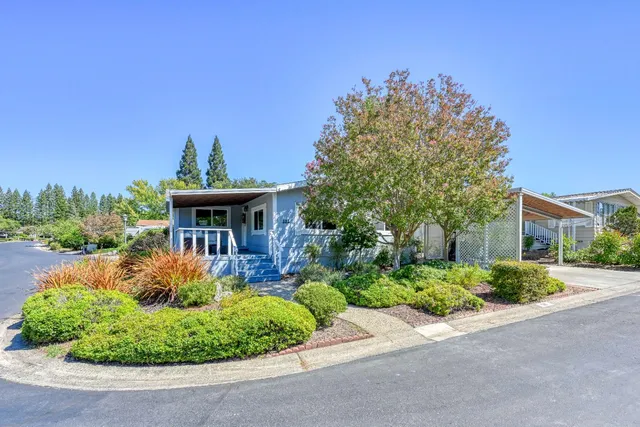 a view of a house with a small yard and a garden