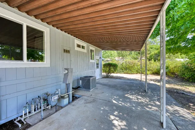 a backyard of a house with table and chairs