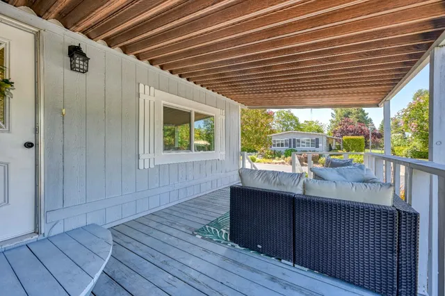 a view of a porch with wooden floor and outdoor space