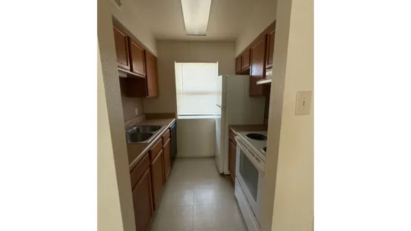 a kitchen with a refrigerator and a stove