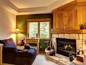 655 4 O Clock Road, Unit 109 Breckenridge, CO 80424 - Photo 3 of 17 a living room with furniture and a fireplace