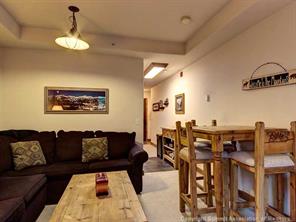 655 4 O Clock Road, Unit 109 Breckenridge, CO 80424 - Photo 5 of 17 a living room with furniture and a chandelier