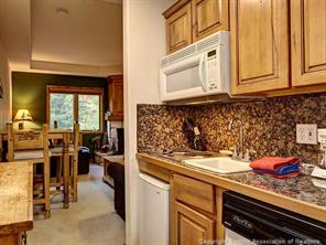 655 4 O Clock Road, Unit 109 Breckenridge, CO 80424 - Photo 6 of 17 a kitchen with stainless steel appliances granite countertop a sink and cabinets