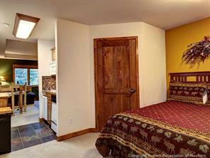 655 4 O Clock Road, Unit 109 Breckenridge, CO 80424 - Photo 7 of 17 a bedroom with a bed and a painting on the wall