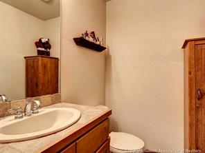 655 4 O Clock Road, Unit 109 Breckenridge, CO 80424 - Photo 8 of 17 a bathroom with a granite countertop sink and a mirror