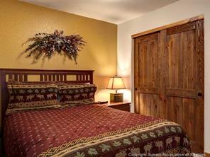 655 4 O Clock Road, Unit 109 Breckenridge, CO 80424 - Photo 9 of 17 a bedroom with a bed and a night stand
