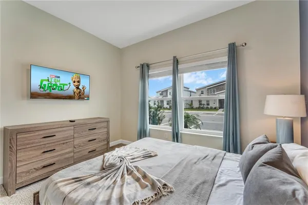 a bedroom with a bed and a painting on the wall