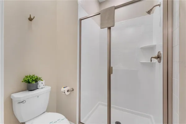 a bathroom with a glass shower door