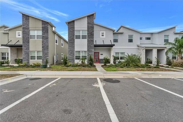 a living room with furniture a rug and a chandelier