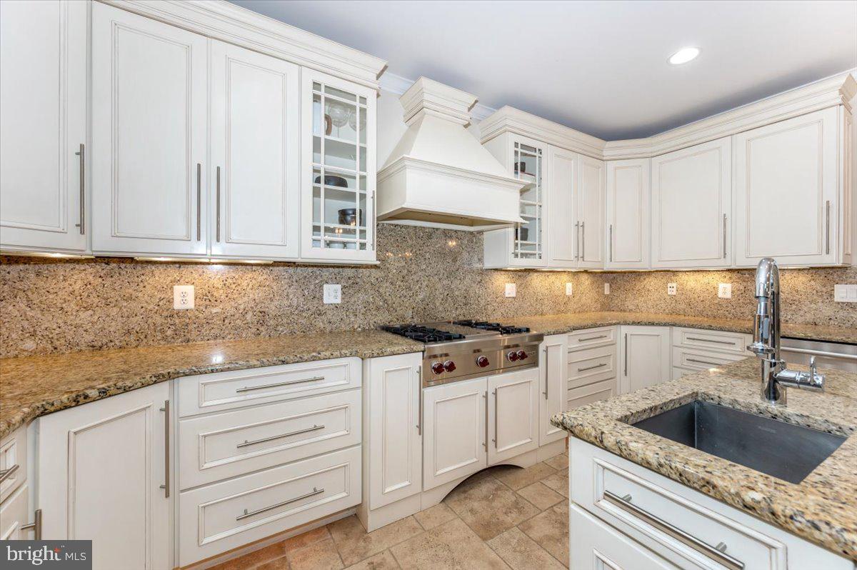 11793 Frederick Road Ellicott City, MD 21042 - Photo 12 of 46 a kitchen with granite countertop white cabinets and white appliances