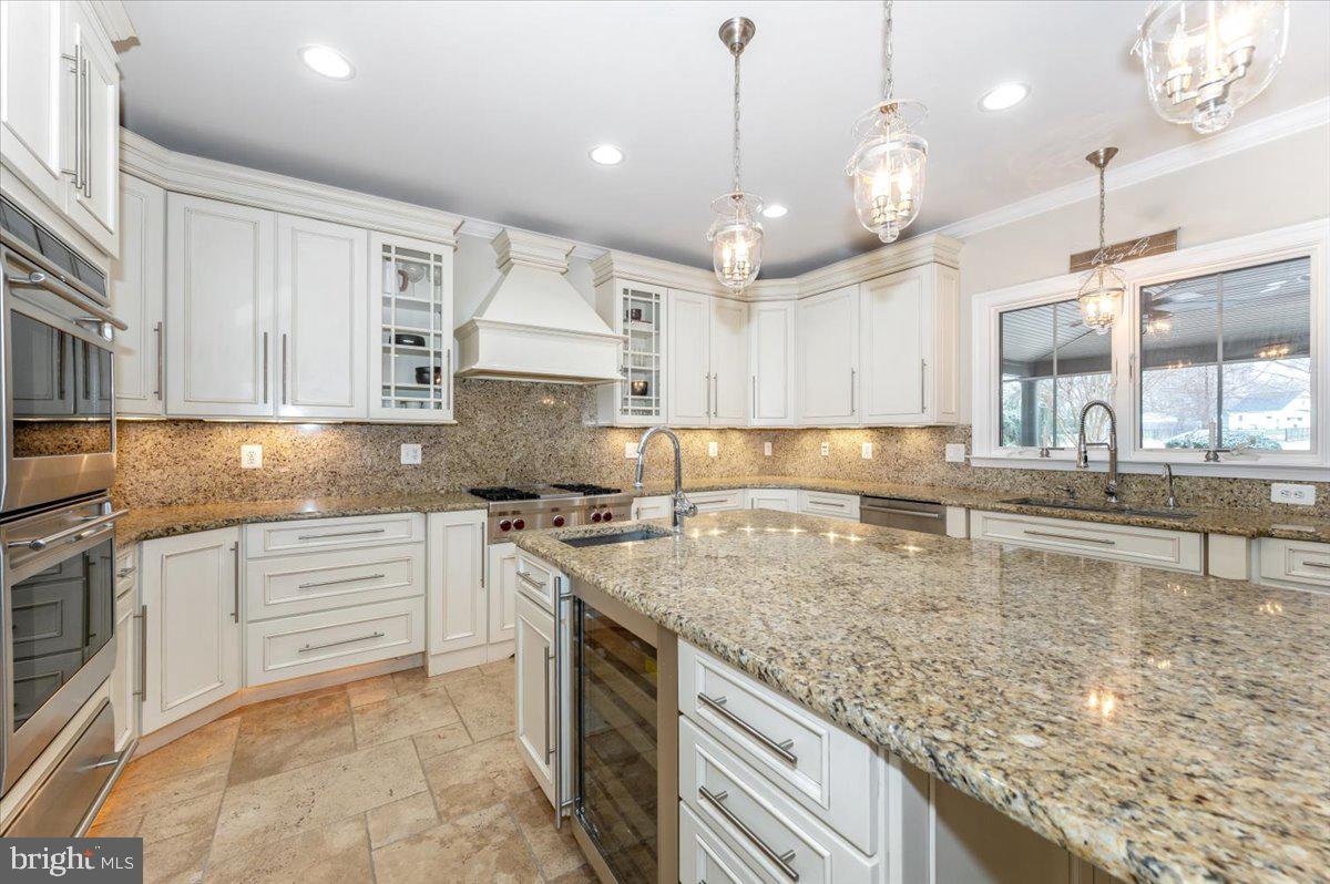 11793 Frederick Road Ellicott City, MD 21042 - Photo 14 of 46 a large kitchen with kitchen island a large counter space a sink appliances and cabinets