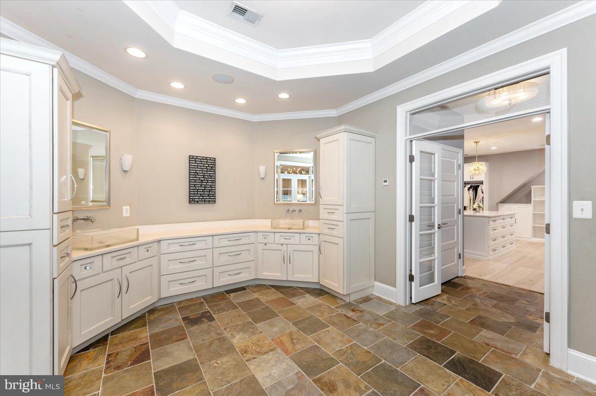 11793 Frederick Road Ellicott City, MD 21042 - Photo 16 of 46 a bathroom with a sink a mirror and a shower