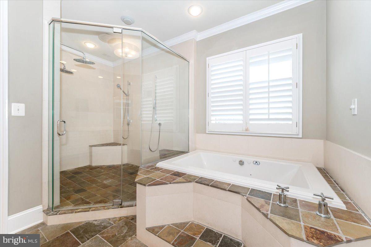 11793 Frederick Road Ellicott City, MD 21042 - Photo 17 of 46 a bathroom with a granite countertop bathtub a sink and a shower