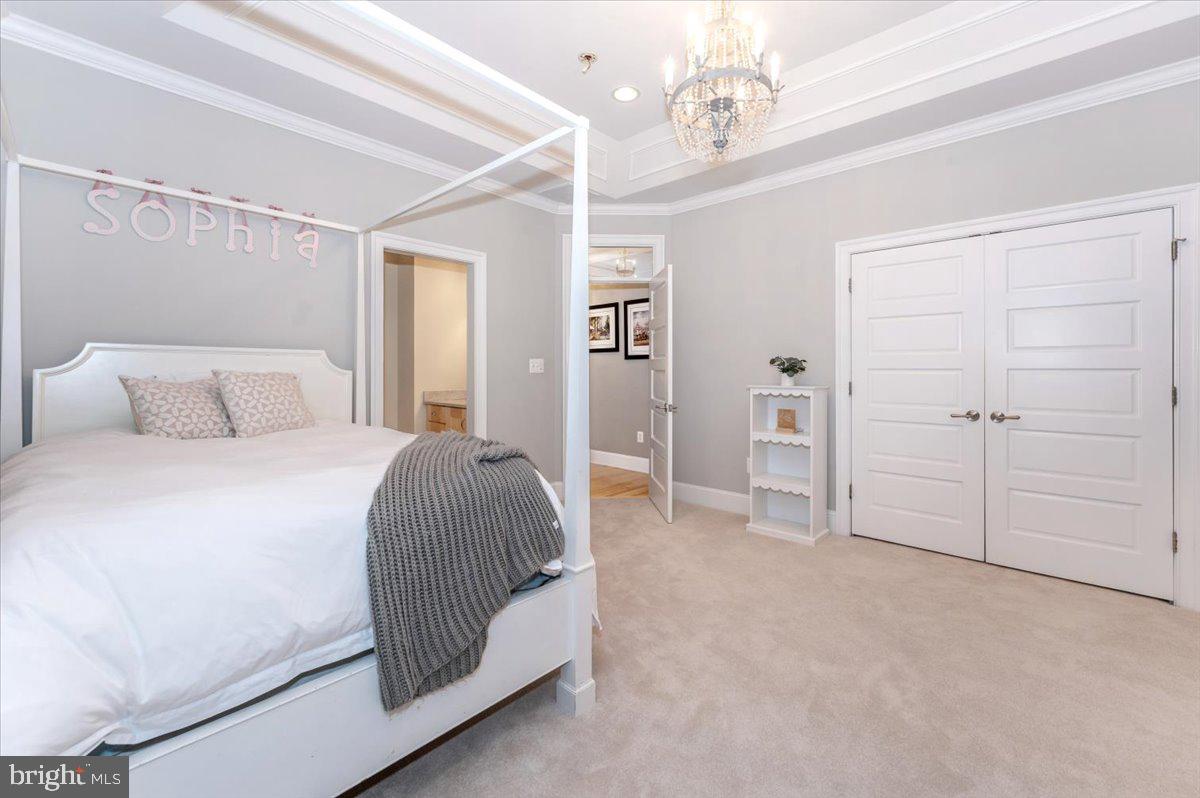 11793 Frederick Road Ellicott City, MD 21042 - Photo 21 of 46 a bedroom with a bed and a chandelier