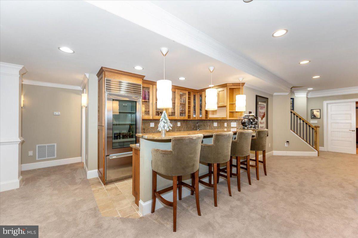 11793 Frederick Road Ellicott City, MD 21042 - Photo 24 of 46 a dining room with stainless steel appliances kitchen island granite countertop a table and chairs