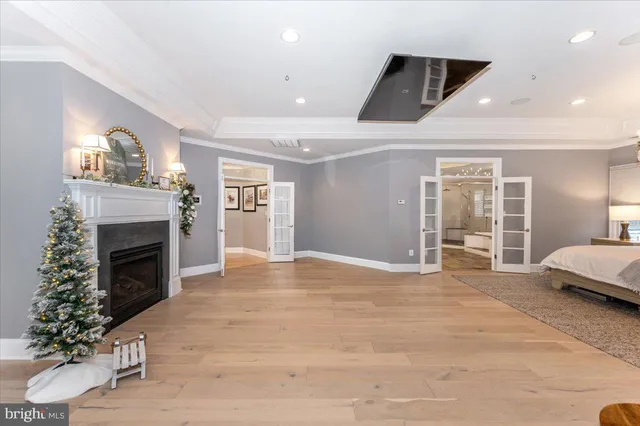 a bedroom with a bed and a flat tv screen on dresser