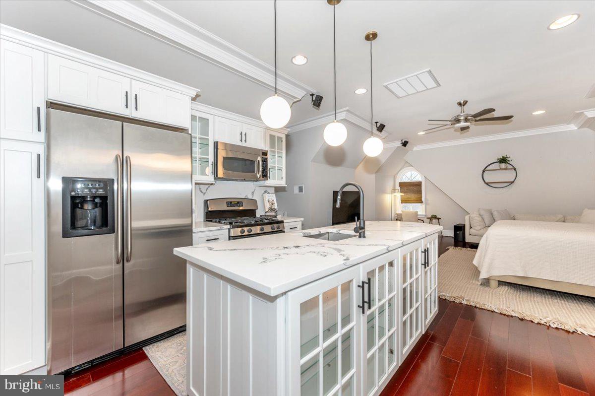 11793 Frederick Road Ellicott City, MD 21042 - Photo 30 of 46 a kitchen with stainless steel appliances a stove a refrigerator a chimney a sink and a refrigerator