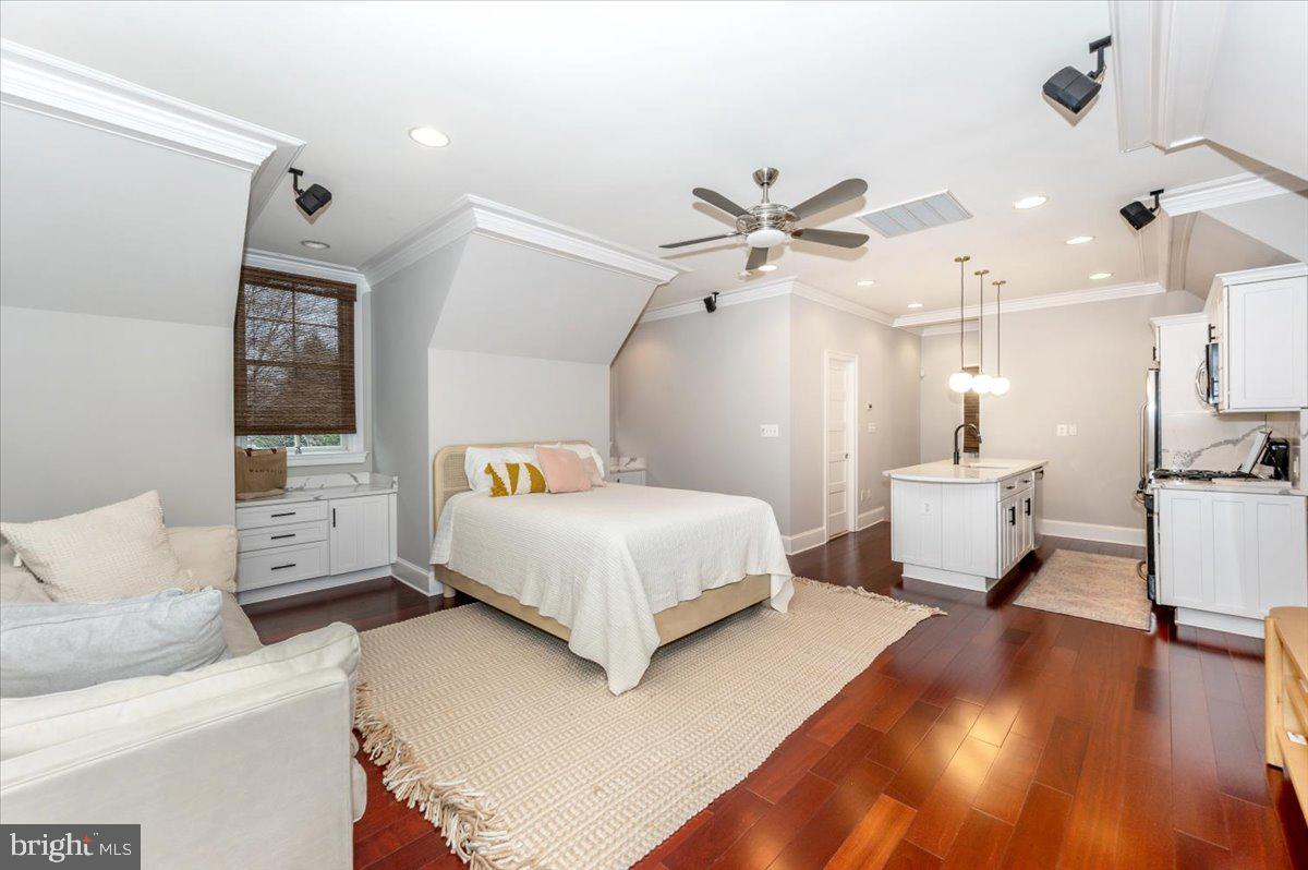 11793 Frederick Road Ellicott City, MD 21042 - Photo 32 of 46 a bedroom with a large bed and a chandelier