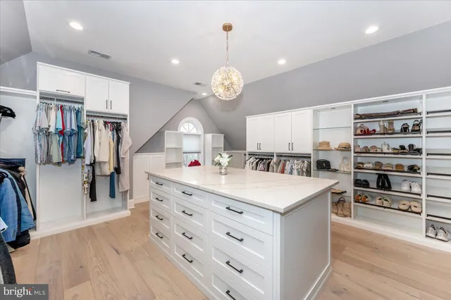 a living room with hard wood floor pool table and furniture