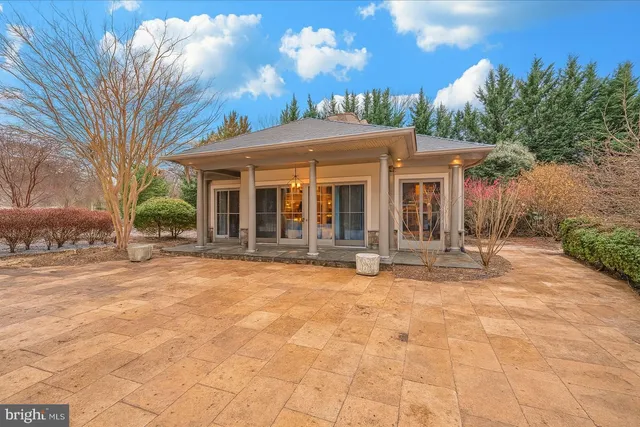 a view of a house with backyard porch and sitting area