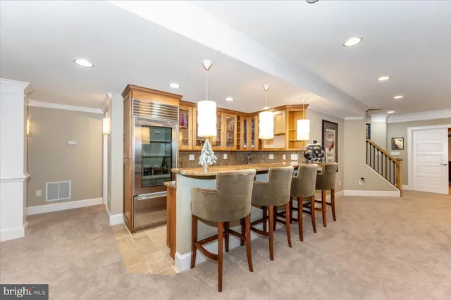 a view of an empty room with a fireplace and a chandelier