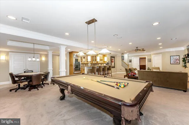 a view of a white house with a yard and entertaining space