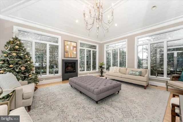 a living room with furniture large window and a fireplace