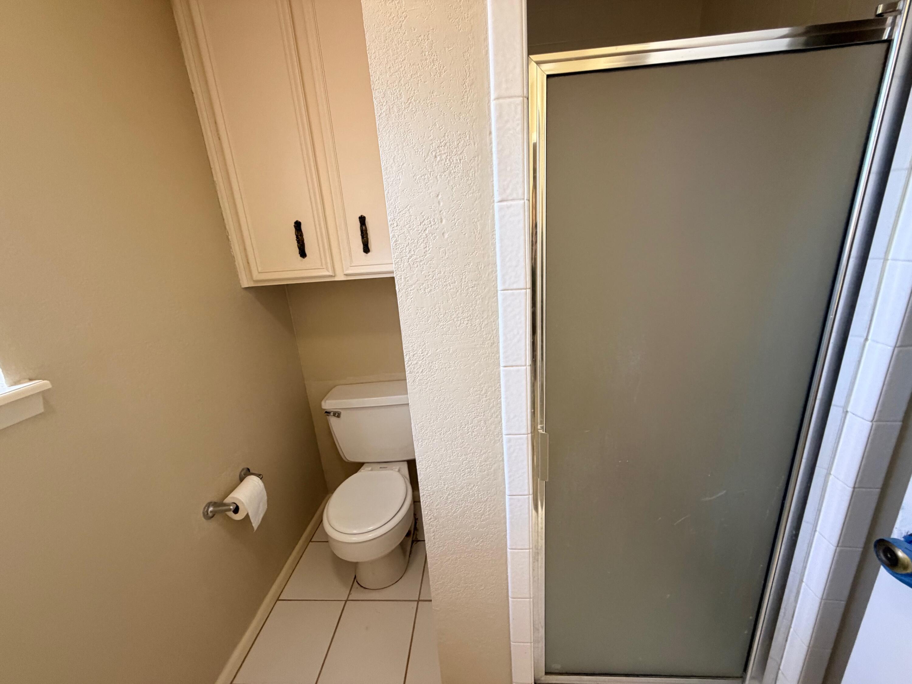 3314 81st Street, Unit B Lubbock, TX 79423 - Photo 13 of 18 a bathroom with a granite countertop toilet and a shower