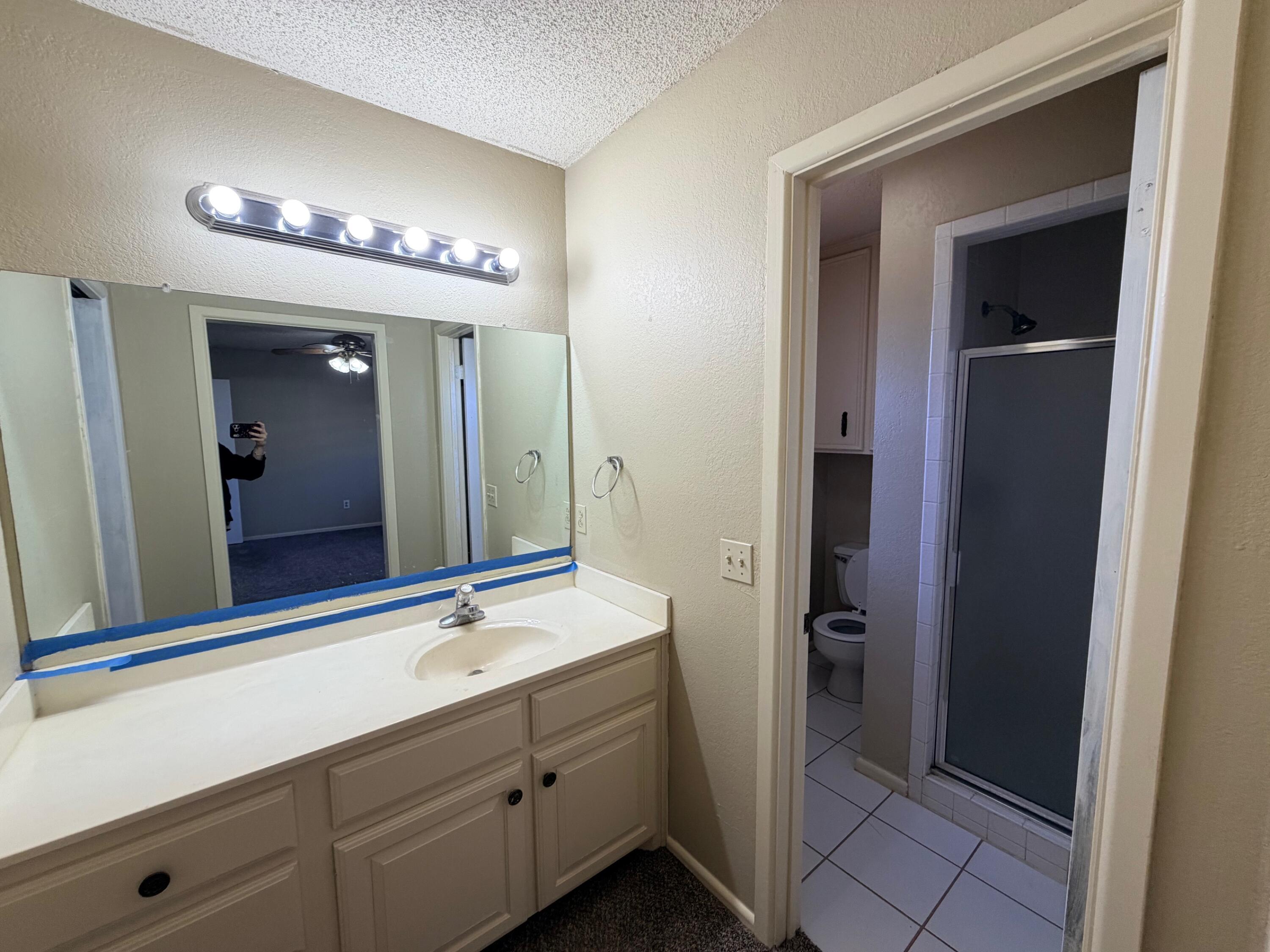 3314 81st Street, Unit B Lubbock, TX 79423 - Photo 14 of 18 a bathroom with a double vanity sink and a mirror
