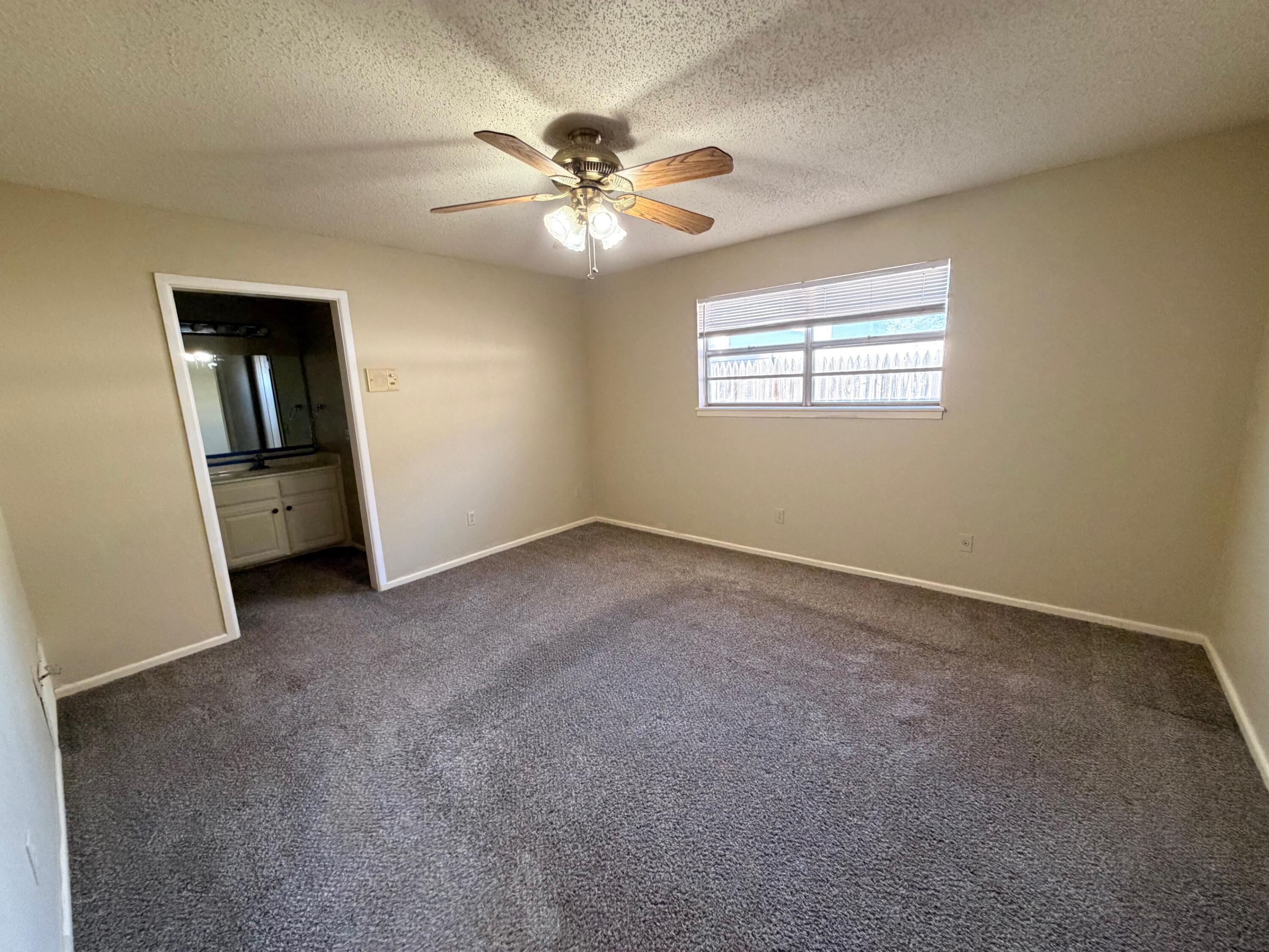 3314 81st Street, Unit B Lubbock, TX 79423 - Photo 15 of 18 a view of a livingroom with a ceiling fan and window