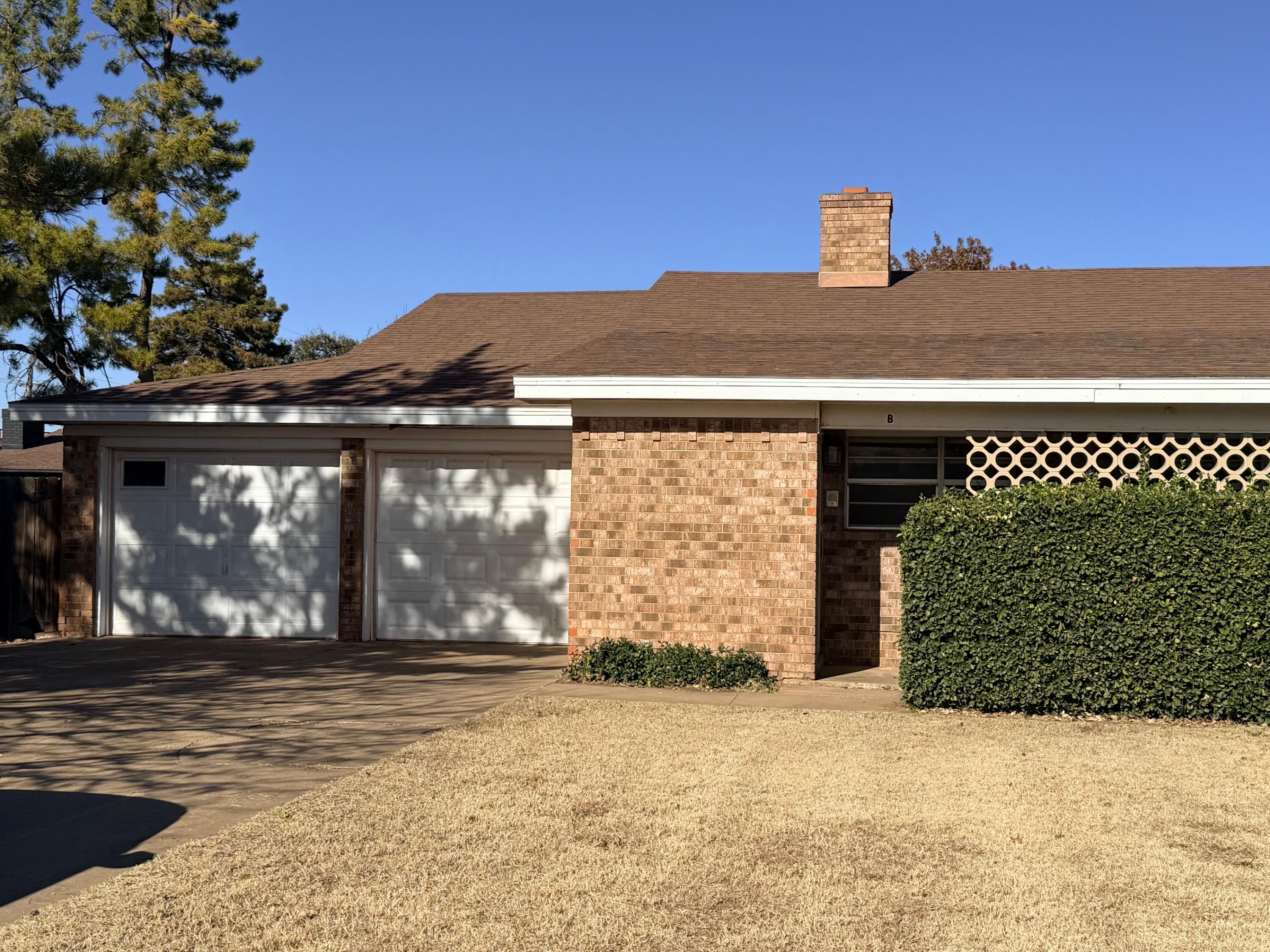3314 81st Street, Unit B Lubbock, TX 79423 - Photo 2 of 18 a front view of a house with a yard