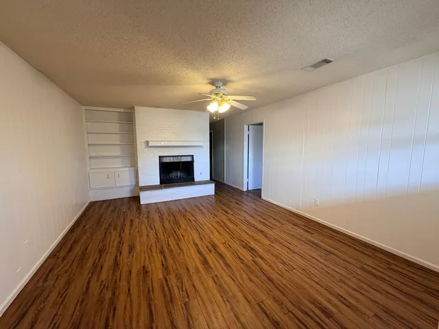 wooden floor fireplace and natural light in room