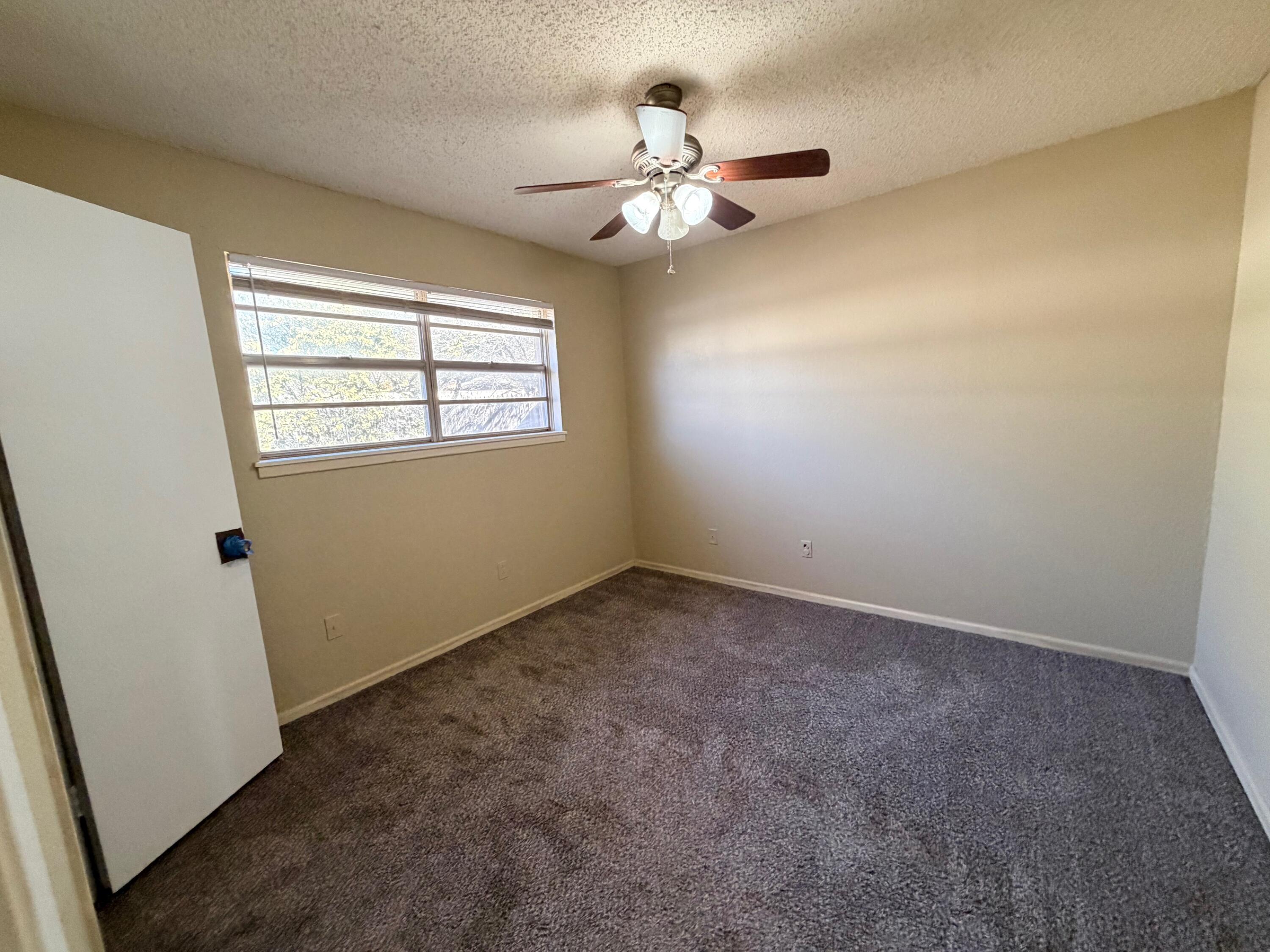 3314 81st Street, Unit B Lubbock, TX 79423 - Photo 6 of 18 an empty room with windows and fan